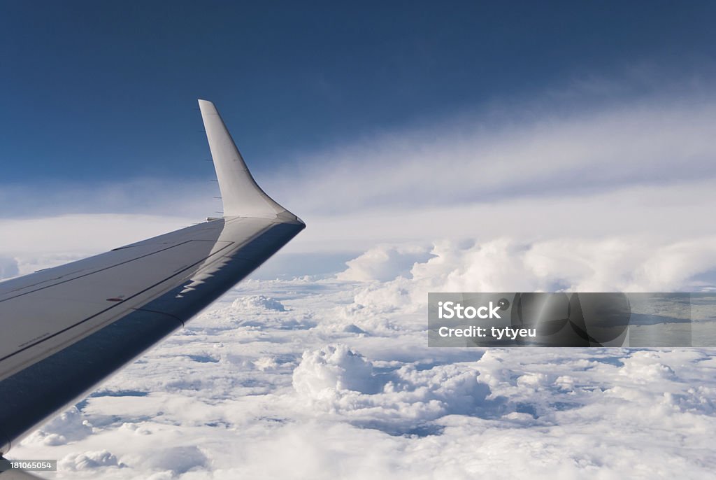 Airplane wing Airplane wing and white clouds below. Aerial View Stock Photo