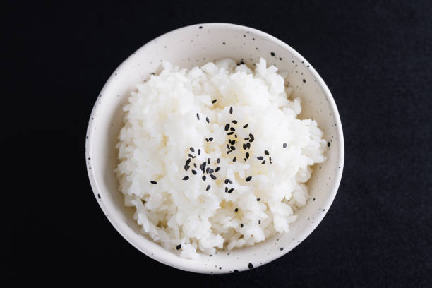 istock Japanese rice on cup isolated in black background 1810657407