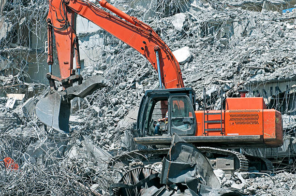 istock Crane separating concrete from metal with shovel attachmenthment 181065885