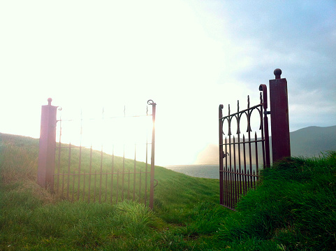 Open Gate in landscape with bright light in the sky
