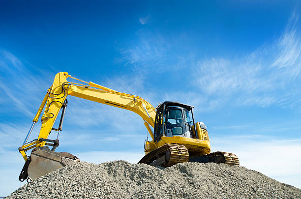 istock Backhoe on a Gravel Pile 181066246