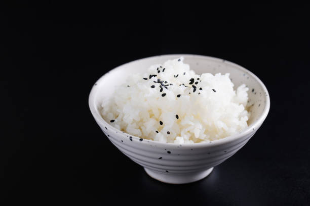 istock Japanese rice on cup isolated in black background 1810663060