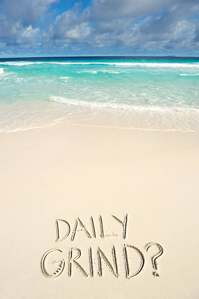 istock Daily Grind Message on Bright Tropical Beach 181066608