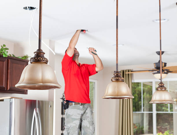 Ligting installation Man installing ceiling pendant lights and recessed lighting in kitchen light fixture stock pictures, royalty-free photos & images