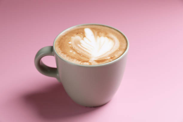 istock hot cappuccino with latte art isolated in pink background 1810669916