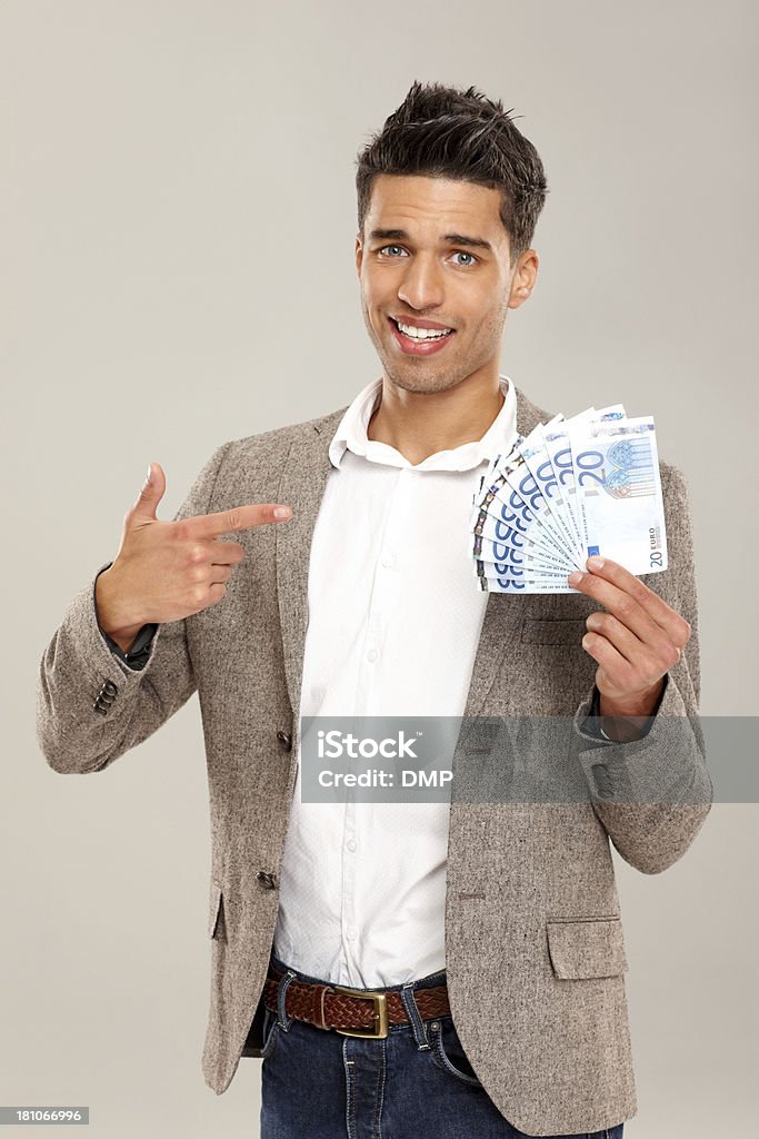 Feliz joven apuntando en dinero en la mano - Foto de stock de Felicidad libre de derechos