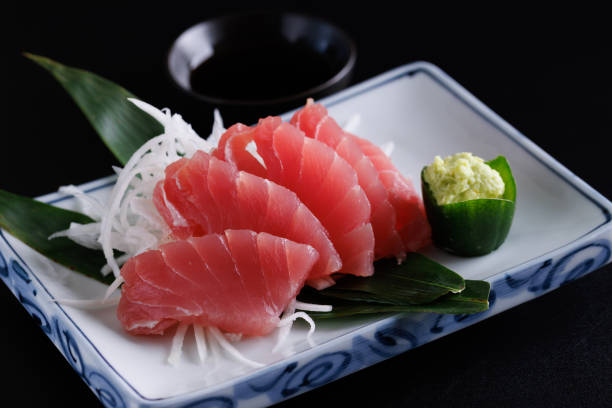 istock Tuna sashimi isolated in black background 1810672571