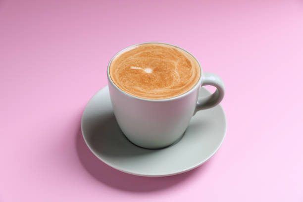 istock hot cappuccino with latte art isolated in pink background 1810672593