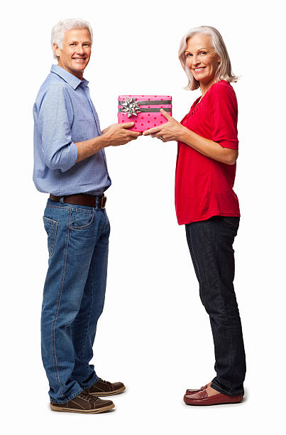 istock Senior Couple Holding Gift Box - Isolated 181067682