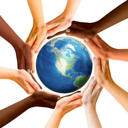 Multiracial human hands and Earth planet