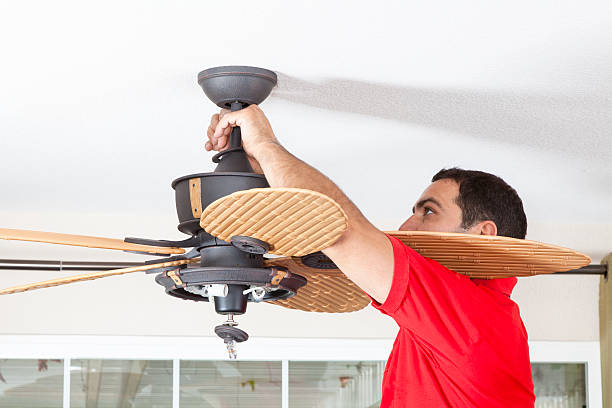 Install Ceiling Fan Men installing ceiling fan. ceiling fan stock pictures, royalty-free photos & images