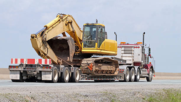 yellow excavator on trailer