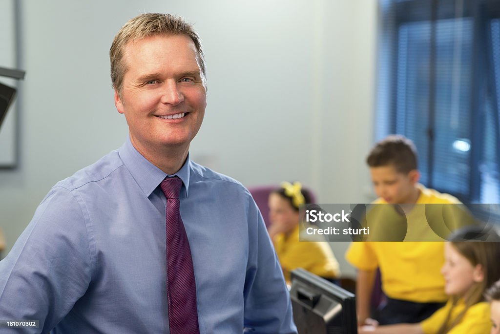 primary school IT class teacher teacher with students in primary school IT class 40-49 Years Stock Photo