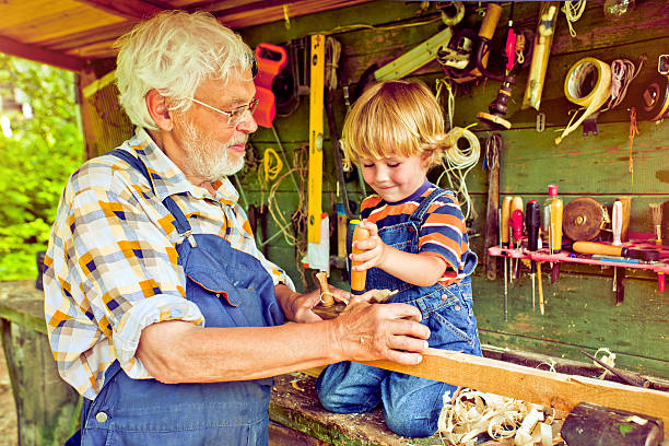istock Grandfather and grandson in workshop 181070572
