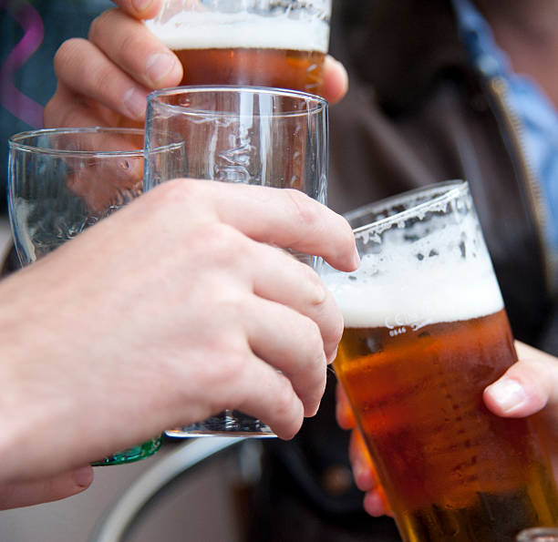istock cheers with beer - beer glasses when toasting 181070585