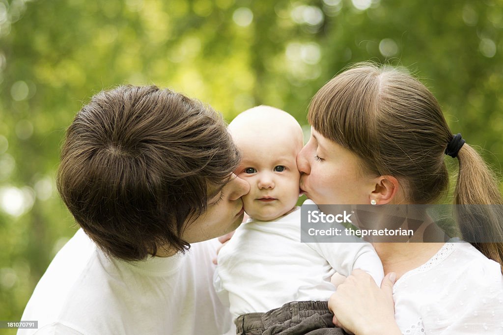 Happy parents kissing their cute baby boy 12-23 Months Stock Photo