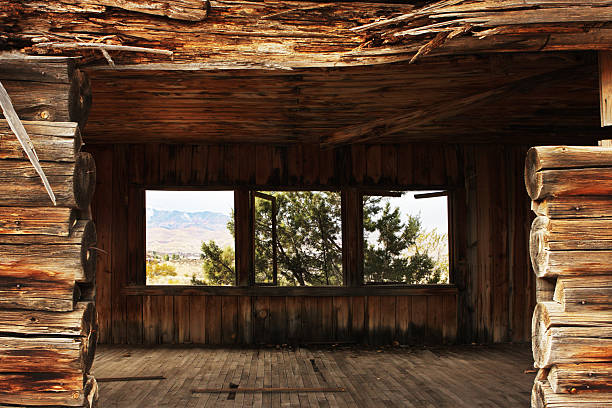 The view through an abandoned log cabin doorway and out through its windows to the desert landscape beyond.  Cottonwood, Arizona, 2013.