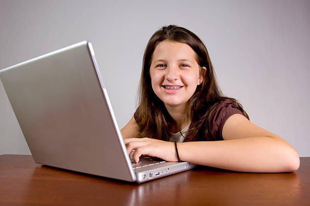 istock Young girl and her laptop 181071067