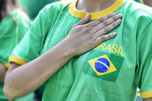 ventilador brasilian putting mano sobre el corazón durante el himno nacional - championship 2014 brazil brazilian fotografías e imágenes de stock