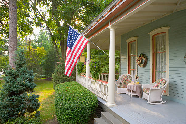 Summertime on a Victorian porch American Flag and a Quaint Victorian Style Veranda charming stock pictures, royalty-free photos & images