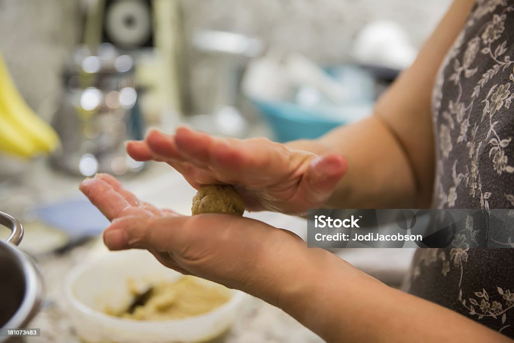 Woman cooking matzoh balls Woman making a matzoh ball to cook for passover.RM.  rr Passover Stock Photo