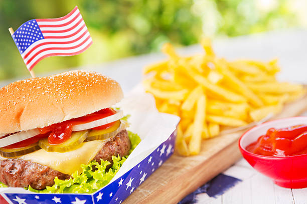 istock Burger with fries on an outdoor table in bright light 181073489