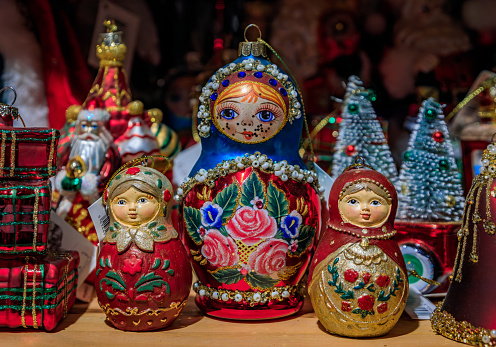 Colmar, France - June 5, 2023: Colorful Christmas ornaments and traditional Russian matryoshka nesting dolls for sale, a souvenir shop in the old town