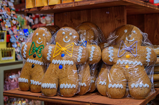 Traditional artisanal handmade Alsatian gingerbread man holiday cookies on display at a store in the old town Colmar, France