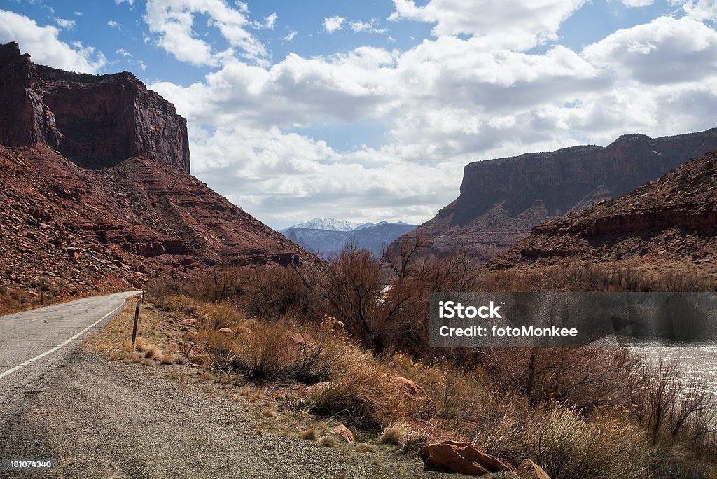 Scenic Byway 128, Colorado River, Moab, Utah, USA Wide angled view of Scenic Byway 128 running next to the Colorado River with Fisher Towers and the La Sal Mountains in the distance.Similar images: Arid Climate Stock Photo