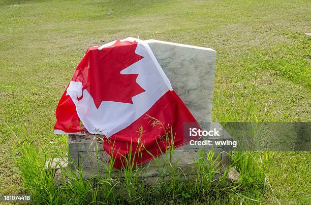 Canadian Flag Draped Over A Tombstone With Green Grass Stock Photo - Download Image Now
