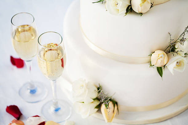 istock White Wedding Cake And Champagne Flutes On Table 181074561