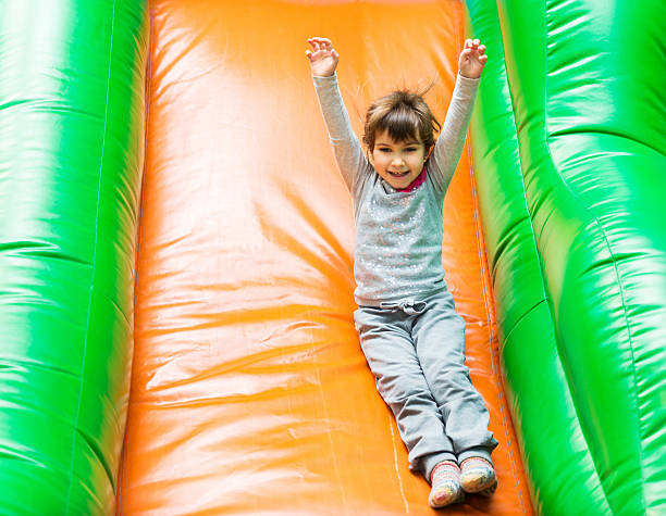 istock Girl on an inflatable slide. 181075850