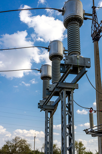 Gas-insulated current transformers at a high-voltage substation.