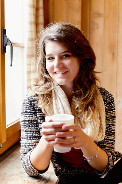 istock Cheerful young girl holding a coffe cup 181076223