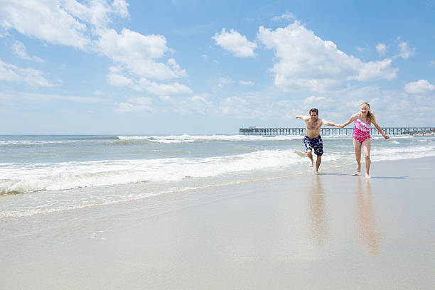 istock Happy father and daughter running oceanside 181076308