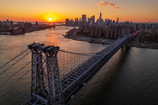 Sunset over Williamsburg Bridge with the view of Lower Manhattan on the background. New York City