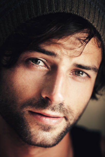 Portrait of an attractive and ruggedly handsome man wearing a woolen cap