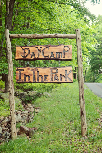 Day Camp in the Park sign curved in wood