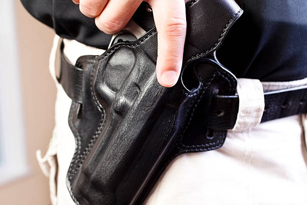 Law: Undercover detective ready to draw gun weapon from leather holster
