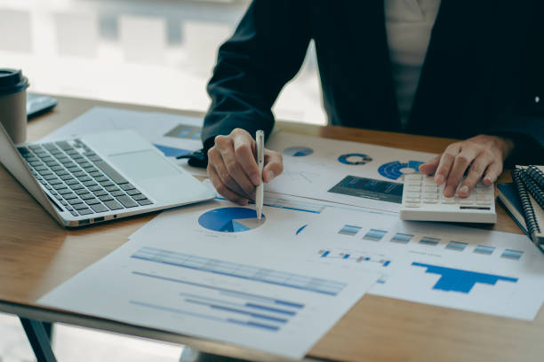 istock Businessman pointing at business document for chart and graph data analysis and accounting business woman holding pen and pointing at financial documents to analyze profit concept 1810771327