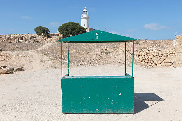 lighthouse in Paphos archeological site empty green information booth  Cyprus