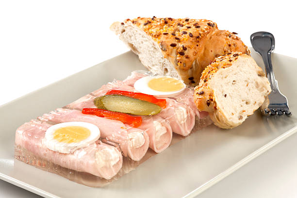 Rolls of ham in aspic Snack with rolls of ham stuffed horseradish with eggs, cucumber and pepper in aspic on plate with pastry. aspic stock pictures, royalty-free photos & images