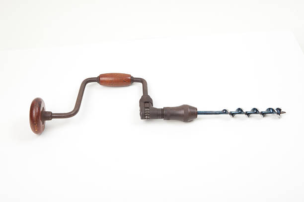 Old hand drill isolated on white background.