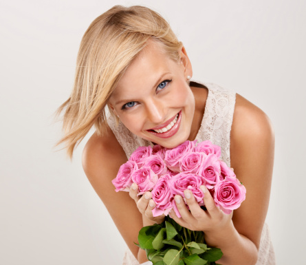 Portrait of an attractive young woman holding a bouquet of flowers