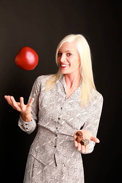 istock woman with apple and candy 181077780