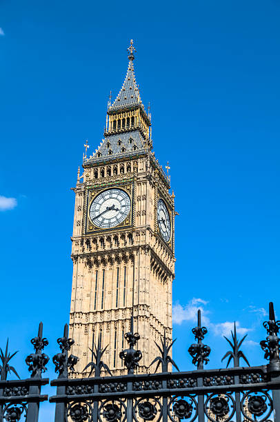 istock Big Ben Tower under Blue Sky with Ornate Iron Gate 181077948