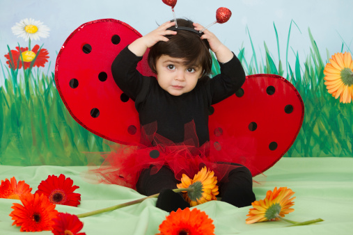 Adorable 12 months baby girl dressed as a ladybug