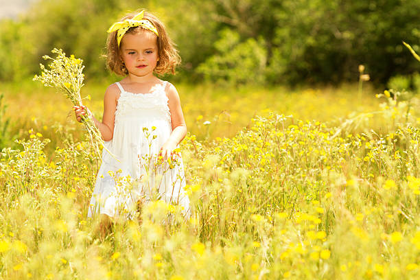 istock Little girl in meadow 181078350