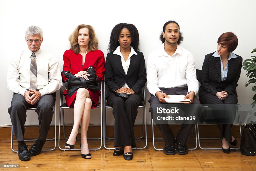 Waiting room A diverse group of people wait in waiting room. Interview - Event Stock Photo