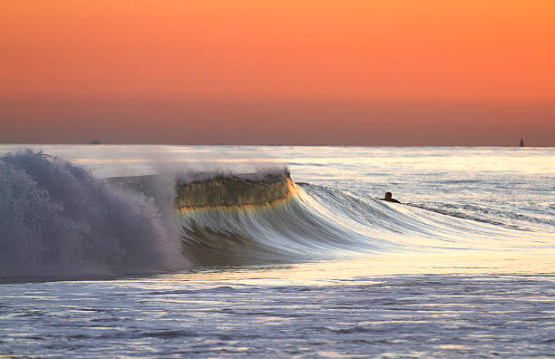 Sunset Surf A beautiful California coastal sunset with a wave breaking. san clemente california stock pictures, royalty-free photos & images